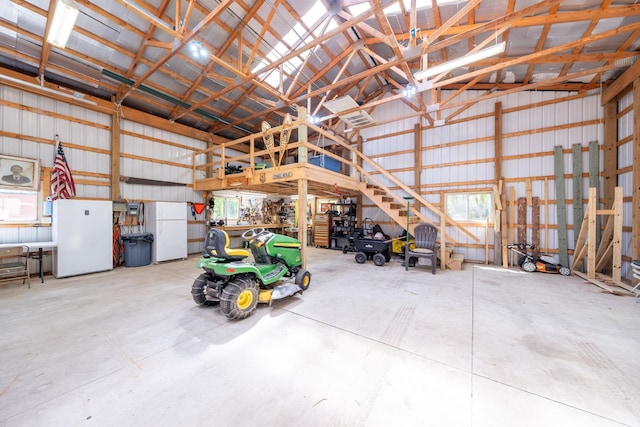 16545 Lonesome Trl, Leroy, MI 49655 - garage with freestanding refrigerator and metal wall