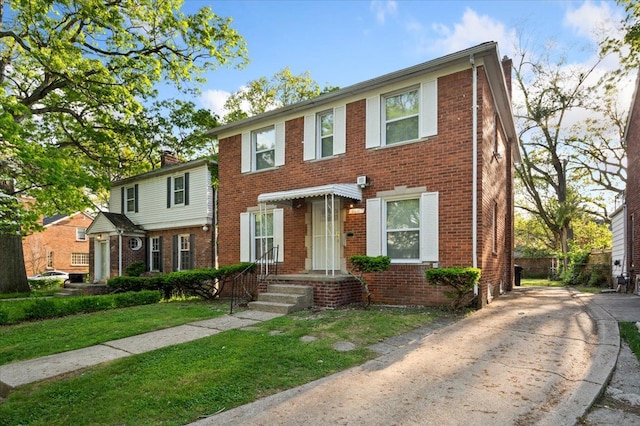 18611 Pinehurst St, Detroit, MI 48221 - townhome / multi-family property with brick siding, a front yard, and driveway