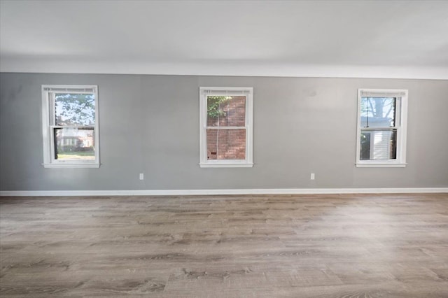 18611 Pinehurst St, Detroit, MI 48221 - empty room with healthy amount of natural light and wood finished floors