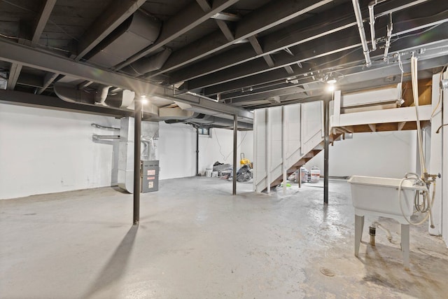 unfinished below grade area with stairs and heating unit