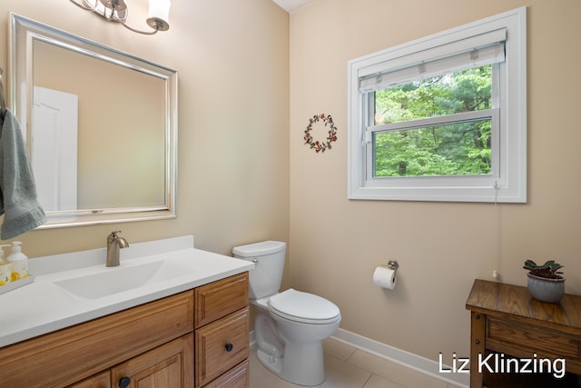 966 Timber Winds Dr SW, Grand Rapids, MI 49534 - half bathroom with vanity, toilet, tile patterned flooring, and baseboards