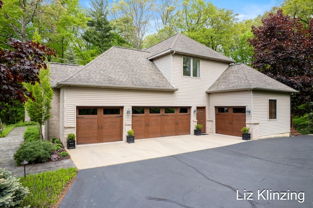 966 Timber Winds Dr SW, Grand Rapids, MI 49534 - view of side of home featuring driveway, roof with shingles, and an attached garage