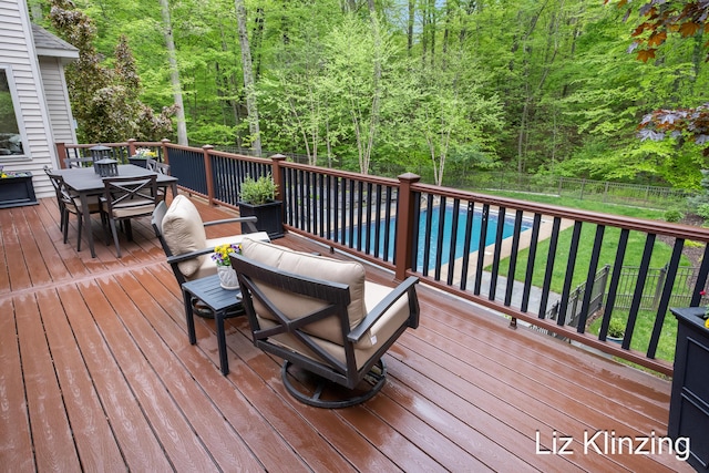 966 Timber Winds Dr SW, Grand Rapids, MI 49534 - wooden deck with outdoor dining area and a wooded view