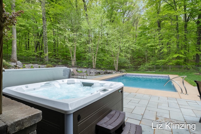 966 Timber Winds Dr SW, Grand Rapids, MI 49534 - view of swimming pool featuring a hot tub, a patio, a wooded view, and a fenced backyard
