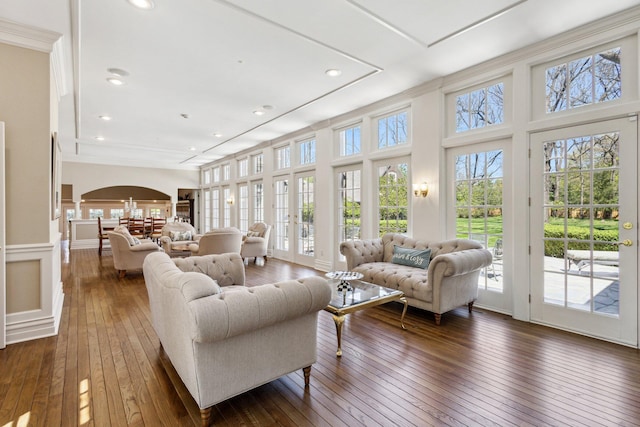 602 N Kalamazoo Ave, Marshall, MI 49068 - living area featuring arched walkways, dark wood finished floors, ornamental molding, recessed lighting, and a chandelier