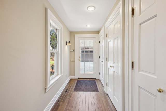 602 N Kalamazoo Ave, Marshall, MI 49068 - doorway featuring baseboards and dark wood-type flooring