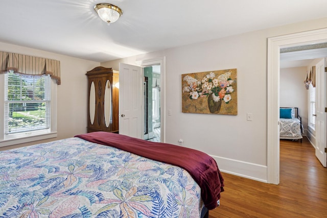 602 N Kalamazoo Ave, Marshall, MI 49068 - bedroom with multiple windows, baseboards, and wood finished floors