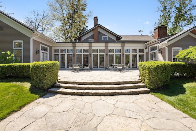 602 N Kalamazoo Ave, Marshall, MI 49068 - rear view of property with a patio, french doors, a chimney, and a yard