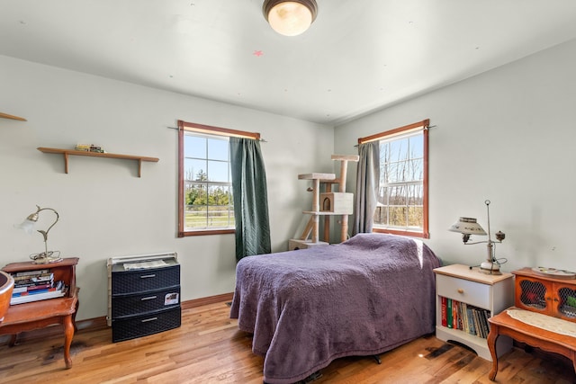 2495 Stitt Rd, Mio, MI 48647 - bedroom featuring multiple windows, wood finished floors, and baseboards