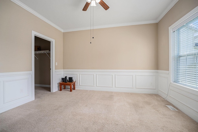 2380 Avalon Woods Dr, Portage, MI 49024 - empty room with healthy amount of natural light, crown molding, light colored carpet, wainscoting, and ceiling fan
