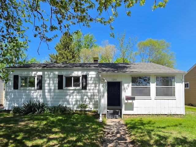 1210 Red Leaf Ln, Ypsilanti, MI 48198 - view of front facade featuring a front lawn, roof with shingles, and a chimney