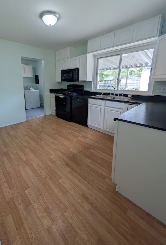 1210 Red Leaf Ln, Ypsilanti, MI 48198 - kitchen with black appliances, a sink, washer / dryer, and dark countertops