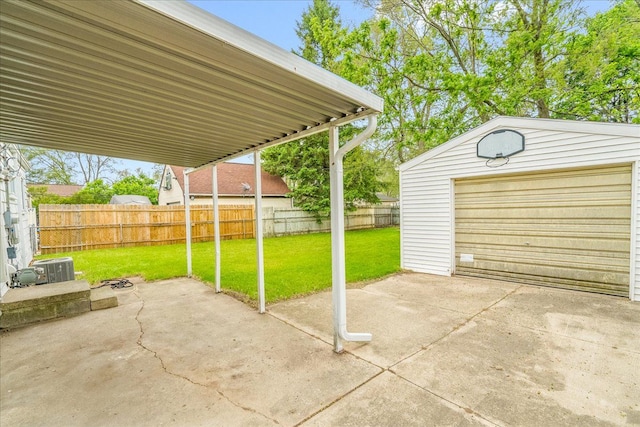 1210 Red Leaf Ln, Ypsilanti, MI 48198 - view of patio featuring driveway, an outdoor structure, and a garage