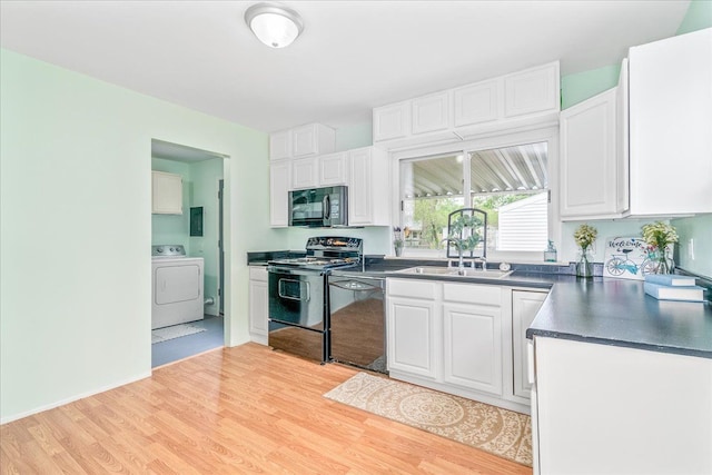 1210 Red Leaf Ln, Ypsilanti, MI 48198 - kitchen with washer / dryer, black appliances, a sink, dark countertops, and white cabinetry