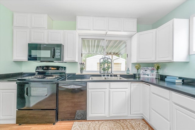 1210 Red Leaf Ln, Ypsilanti, MI 48198 - kitchen featuring black appliances, dark countertops, and white cabinets