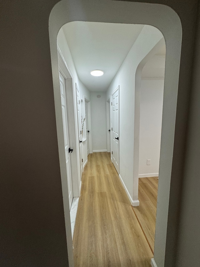 15360 Collinson Ave, Eastpointe, MI 48021 - hall with arched walkways, light wood finished floors, and baseboards