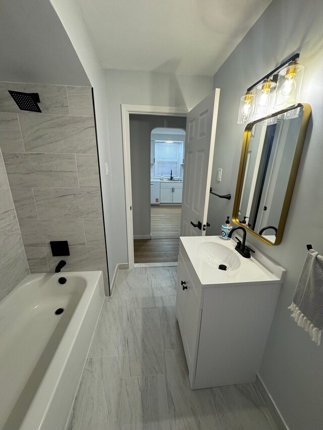 15360 Collinson Ave, Eastpointe, MI 48021 - bathroom with marble look tiles, vanity, baseboards, and shower / bath combination