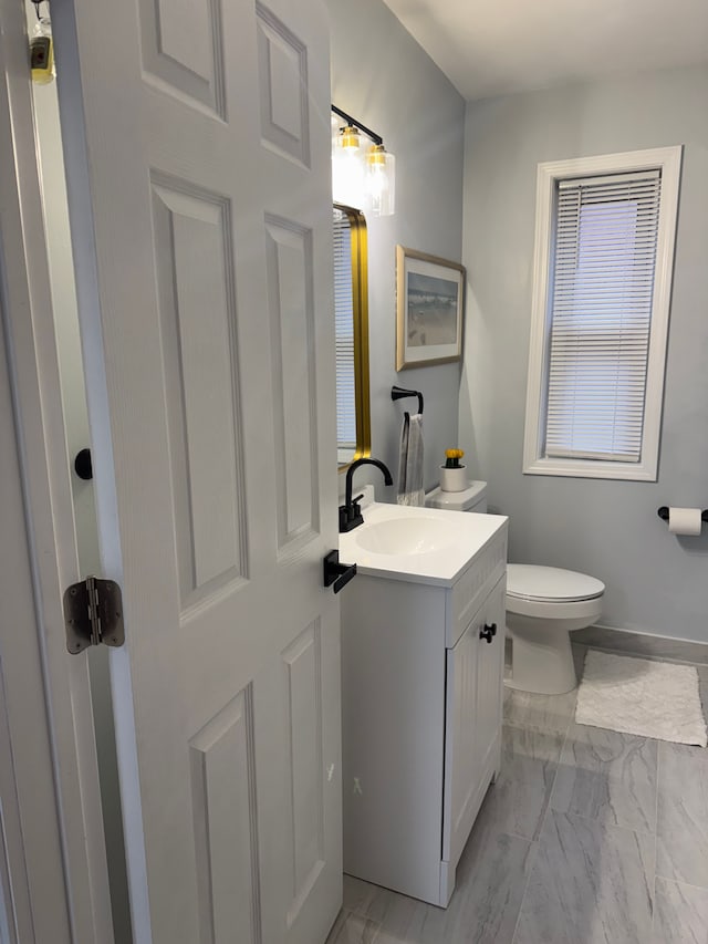 15360 Collinson Ave, Eastpointe, MI 48021 - bathroom featuring marble finish flooring, vanity, and toilet