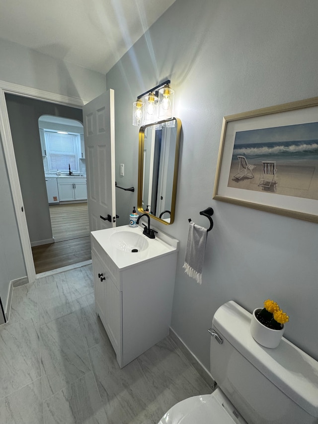 15360 Collinson Ave, Eastpointe, MI 48021 - bathroom with toilet, vanity, baseboards, and marble finish floors