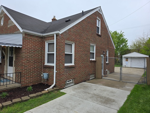 15360 Collinson Ave, Eastpointe, MI 48021 - view of side of home featuring brick siding, a gate, driveway, a chimney, and fence