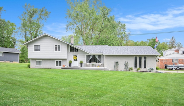 3488 Hilton Estates Dr, Brighton, MI 48114 - back of house with brick siding, a chimney, a lawn, and a wooden deck