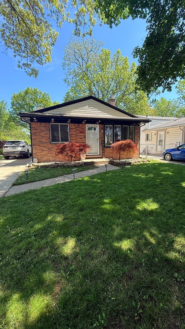 4425 Westpoint St, Dearborn Heights, MI 48125 - ranch-style home with a front yard, a chimney, and brick siding