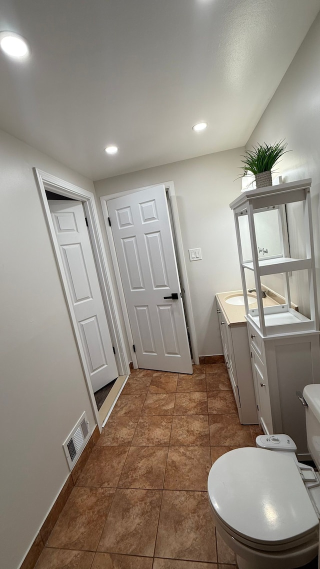 4425 Westpoint St, Dearborn Heights, MI 48125 - bathroom with toilet, vanity, baseboards, and recessed lighting