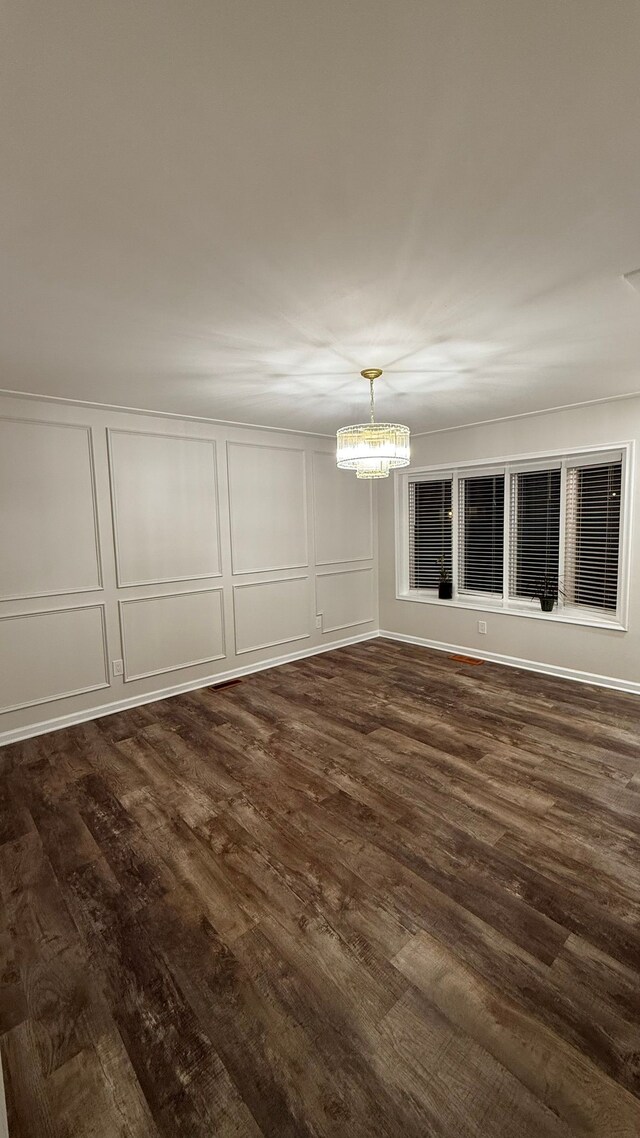 4425 Westpoint St, Dearborn Heights, MI 48125 - unfurnished dining area with a decorative wall, a chandelier, and dark wood-type flooring