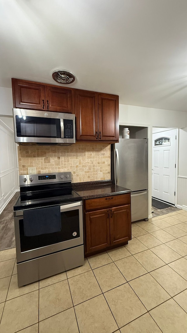4425 Westpoint St, Dearborn Heights, MI 48125 - kitchen featuring stainless steel appliances, dark countertops, and light tile patterned flooring