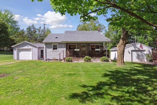 716 Allen St, Caro, MI 48723 - view of front of house featuring covered porch, a detached garage, a front yard, and an outdoor structure