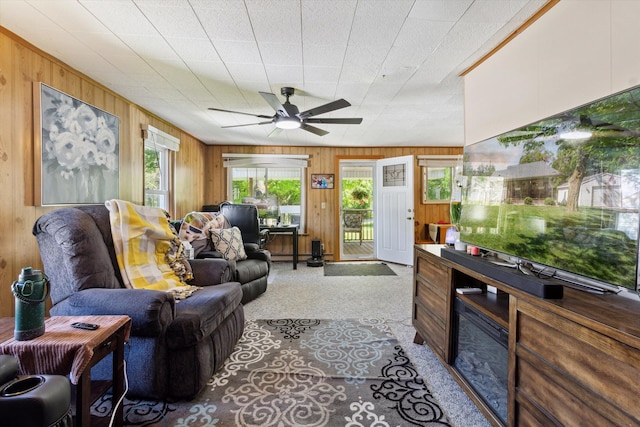 716 Allen St, Caro, MI 48723 - living area featuring wooden walls, light carpet, and ceiling fan