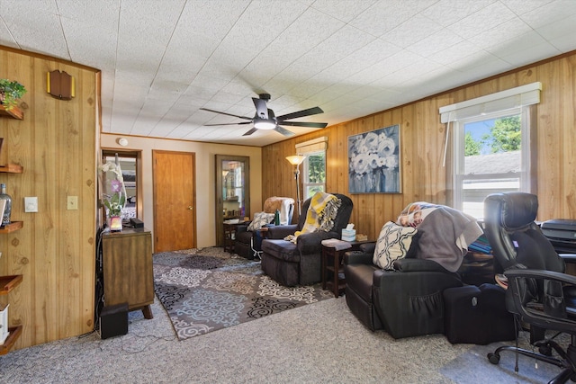 716 Allen St, Caro, MI 48723 - carpeted living area with wood walls, ceiling fan, and a desk