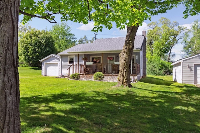 716 Allen St, Caro, MI 48723 - view of front facade with covered porch, a chimney, an outdoor structure, a front lawn, and a detached garage
