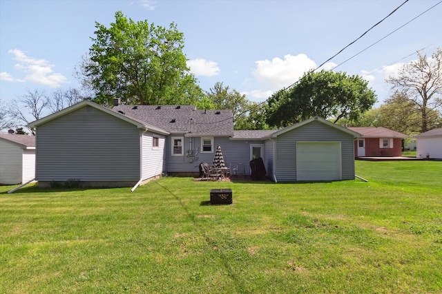 716 Allen St, Caro, MI 48723 - back of property with a lawn, an attached garage, a fire pit, and roof with shingles
