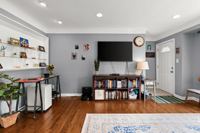 living area with wood finished floors, baseboards, and recessed lighting