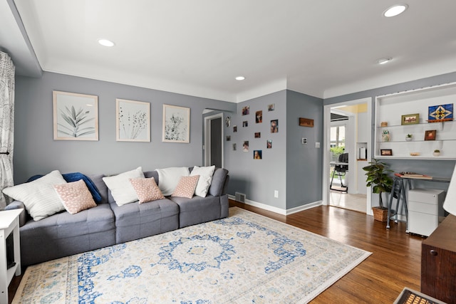 living area with wood finished floors, recessed lighting, and baseboards