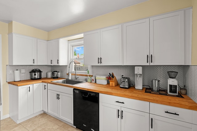 kitchen with wooden counters, dishwasher, a sink, backsplash, and white cabinetry