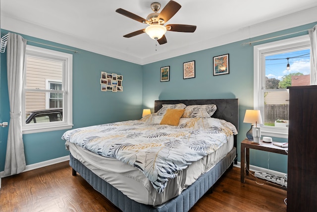 bedroom with baseboards, wood finished floors, and ceiling fan
