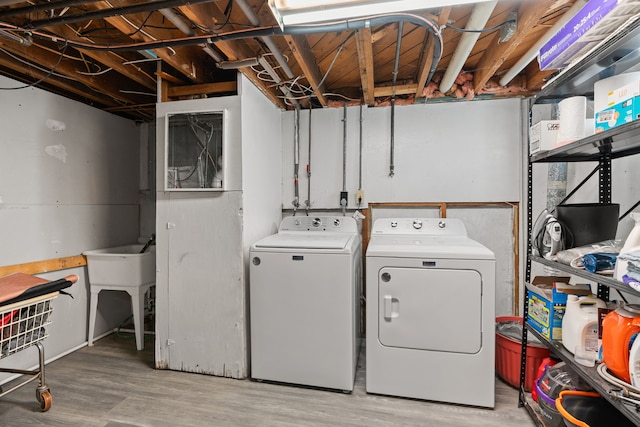 washroom featuring independent washer and dryer and light wood finished floors