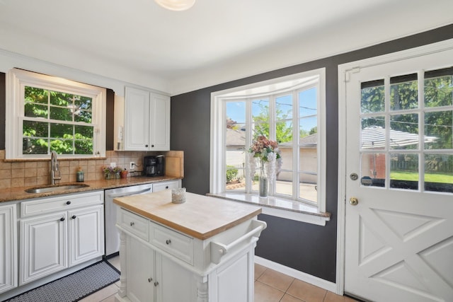 441 Roland Rd, Grosse Pointe Farms, MI 48236 - kitchen with a sink, dishwasher, white cabinetry, decorative backsplash, and light tile patterned floors