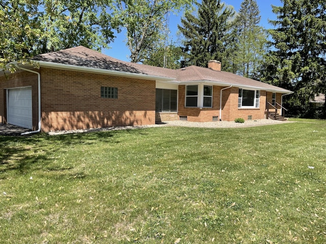 1648 Columbus Ave, Benton Harbor, MI 49022 - rear view of property with brick siding, a garage, a chimney, a lawn, and crawl space