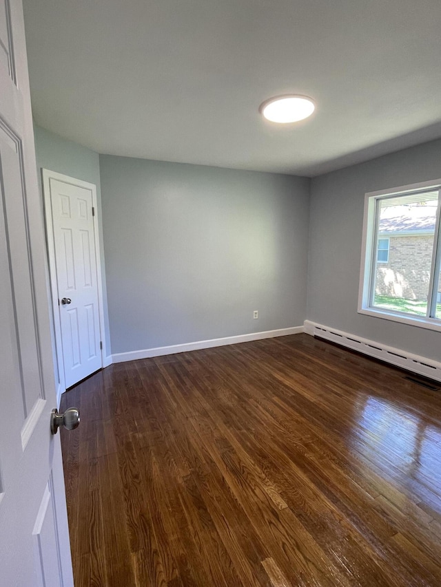 1648 Columbus Ave, Benton Harbor, MI 49022 - empty room featuring dark wood-style floors, baseboard heating, and baseboards