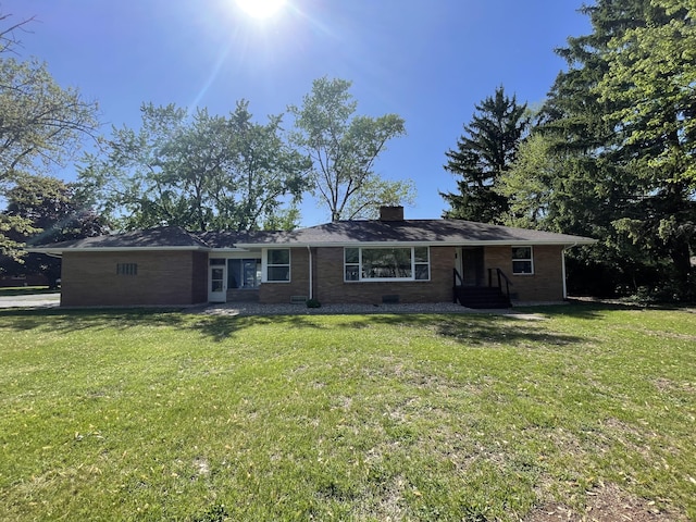 1648 Columbus Ave, Benton Harbor, MI 49022 - single story home featuring a chimney, brick siding, and a front yard