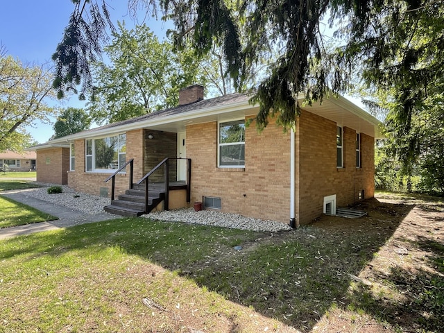 1648 Columbus Ave, Benton Harbor, MI 49022 - ranch-style house with brick siding, a chimney, and a front lawn