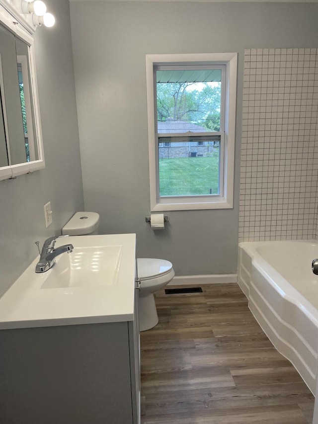 1648 Columbus Ave, Benton Harbor, MI 49022 - full bathroom with toilet, baseboards, vanity, and wood finished floors