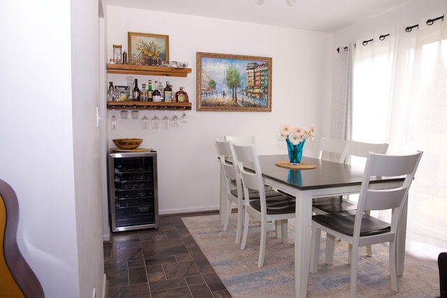 46265 Cavalier Dr, Macomb, MI 48044 - dining room with beverage cooler, a dry bar, and stone finish floors