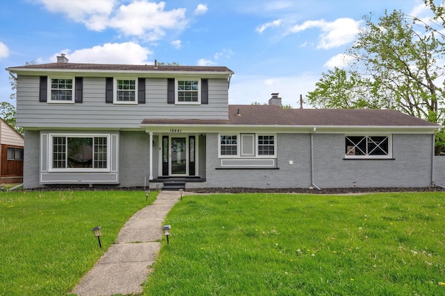 18441 Roseland Blvd, Lathrup Village, MI 48076 - view of front facade with a chimney, a front lawn, and brick siding