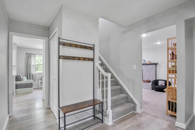18441 Roseland Blvd, Lathrup Village, MI 48076 - staircase featuring wood finished floors, a brick fireplace, and baseboards