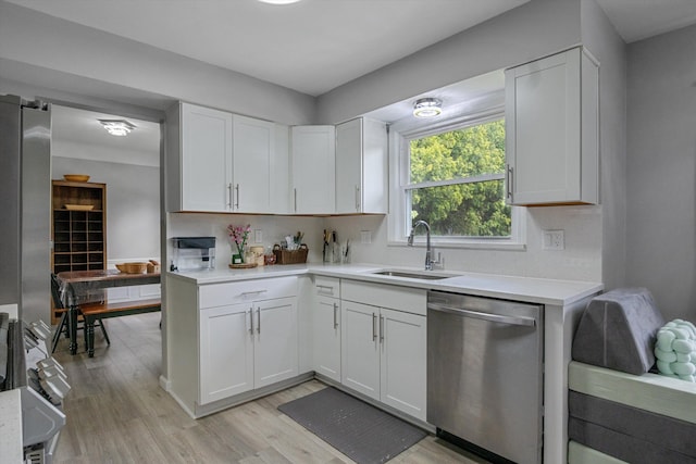 18441 Roseland Blvd, Lathrup Village, MI 48076 - kitchen with dishwasher, a sink, light countertops, light wood-type flooring, and white cabinetry