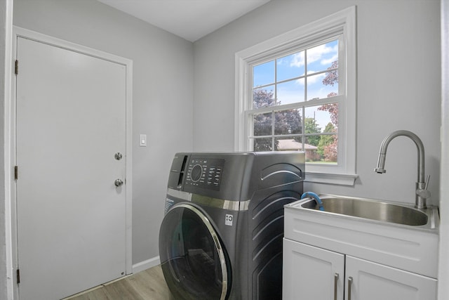 18441 Roseland Blvd, Lathrup Village, MI 48076 - laundry area featuring cabinet space, washer / clothes dryer, light wood-style floors, and baseboards